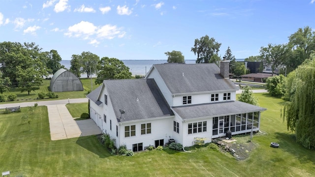 5119 Reynolds Ave, Waunakee, WI 53597 - rear view of house with a sunroom, a chimney, and a yard