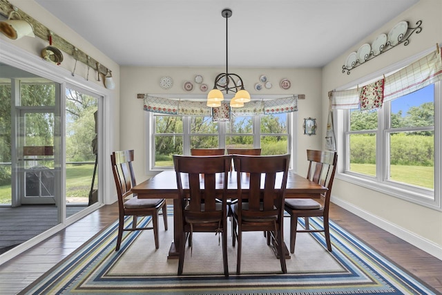 5119 Reynolds Ave, Waunakee, WI 53597 - dining room with a chandelier, dark wood-style floors, and baseboards