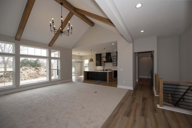 624 Green Bay Rd, Thiensville, WI 53092 - unfurnished living room with a chandelier, beam ceiling, wood finished floors, high vaulted ceiling, and baseboards