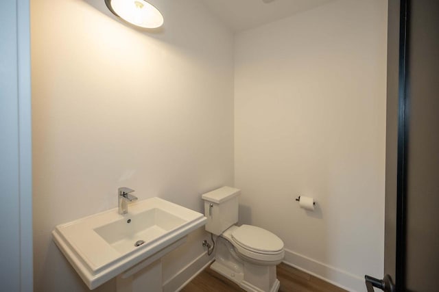 624 Green Bay Rd, Thiensville, WI 53092 - bathroom featuring toilet, baseboards, and wood finished floors