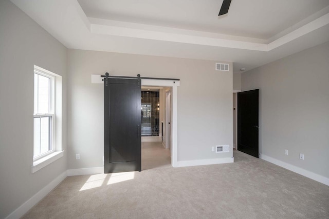 624 Green Bay Rd, Thiensville, WI 53092 - unfurnished bedroom featuring a barn door, light colored carpet, and baseboards