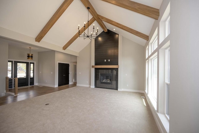 624 Green Bay Rd, Thiensville, WI 53092 - unfurnished living room featuring high vaulted ceiling, carpet, beam ceiling, baseboards, and a chandelier