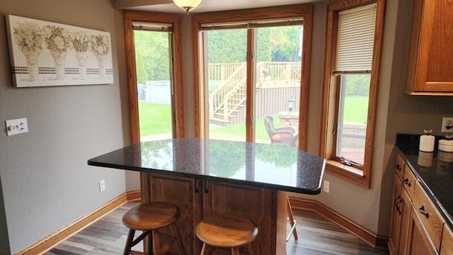 332 River Oaks Dr, Sheboygan Falls, WI 53085 - dining room featuring baseboards, wood finished floors, and a textured wall
