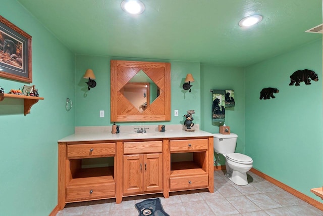 1603 Pine Tree Ln, Luxemburg, WI 54217 - bathroom with toilet, vanity, baseboards, tile patterned floors, and recessed lighting