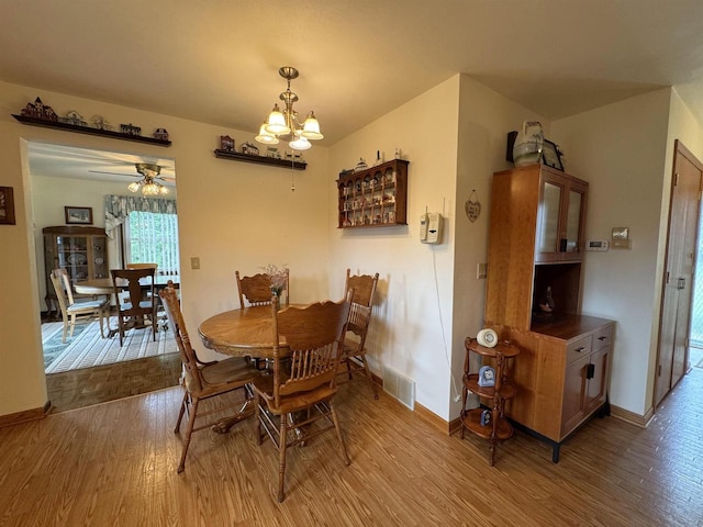 137 24th Ave, Monroe, WI 53566 - dining area with wood finished floors, a chandelier, baseboards, and ceiling fan