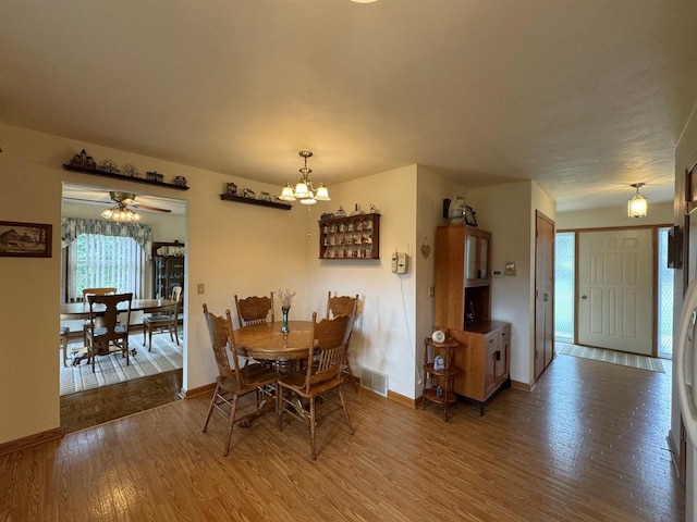 137 24th Ave, Monroe, WI 53566 - dining area featuring wood finished floors, baseboards, and a chandelier