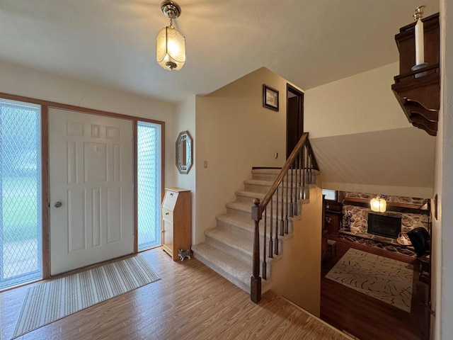 137 24th Ave, Monroe, WI 53566 - foyer featuring a stone fireplace, wood finished floors, and stairway