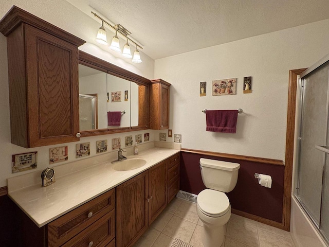 137 24th Ave, Monroe, WI 53566 - full bathroom with vanity, toilet, a textured ceiling, tile patterned floors, and baseboards