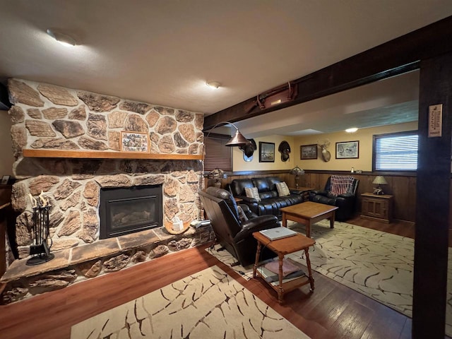 137 24th Ave, Monroe, WI 53566 - living room featuring wood finished floors, a fireplace, beam ceiling, and wooden walls