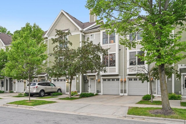 720 Orion Trl, Madison, WI 53718 - view of property featuring driveway, a garage, and a chimney