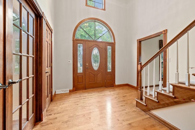 209 E Timberline Dr, Appleton, WI 54913 - entrance foyer featuring light wood finished floors, stairs, a high ceiling, and baseboards