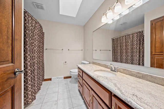 209 E Timberline Dr, Appleton, WI 54913 - bathroom with a skylight, tile patterned floors, vanity, toilet, and baseboards