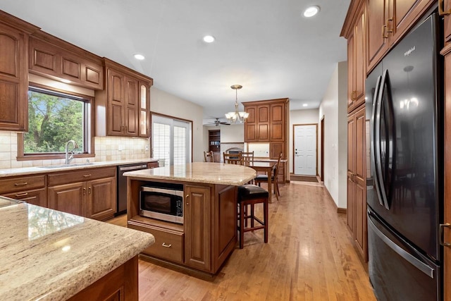 209 E Timberline Dr, Appleton, WI 54913 - kitchen featuring appliances with stainless steel finishes, a sink, a breakfast bar, decorative backsplash, and recessed lighting