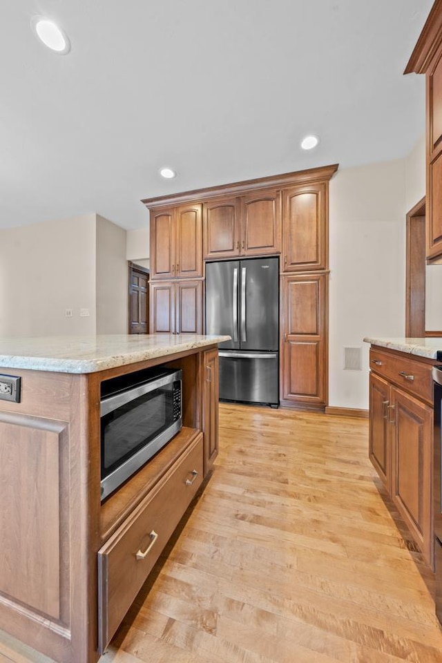 209 E Timberline Dr, Appleton, WI 54913 - kitchen with appliances with stainless steel finishes, light wood-style flooring, light stone counters, recessed lighting, and brown cabinets