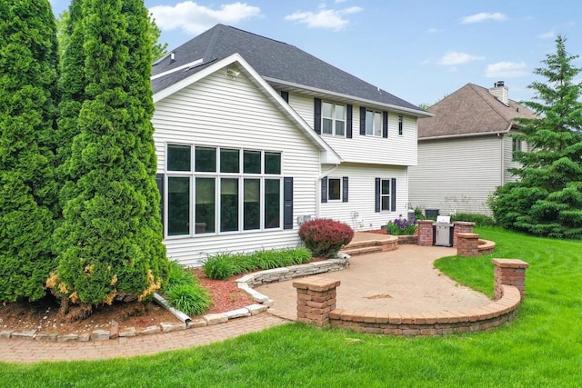 209 E Timberline Dr, Appleton, WI 54913 - rear view of property with a patio area, a lawn, and roof with shingles