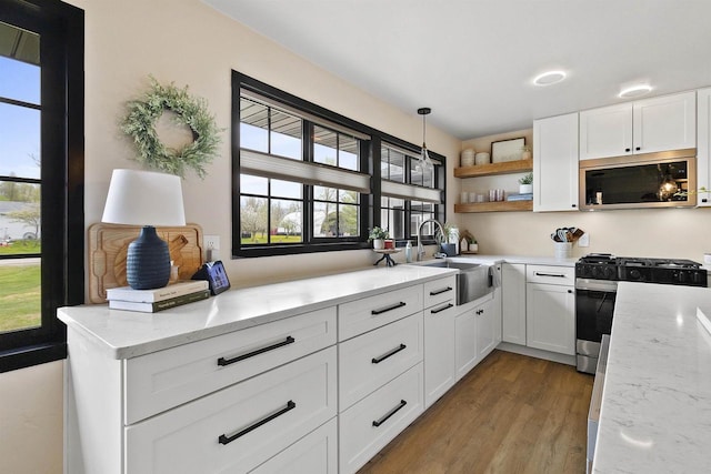 W1691 Fish Creek Rd, Seymour, WI 54165 - kitchen with stainless steel microwave, gas range oven, and healthy amount of natural light