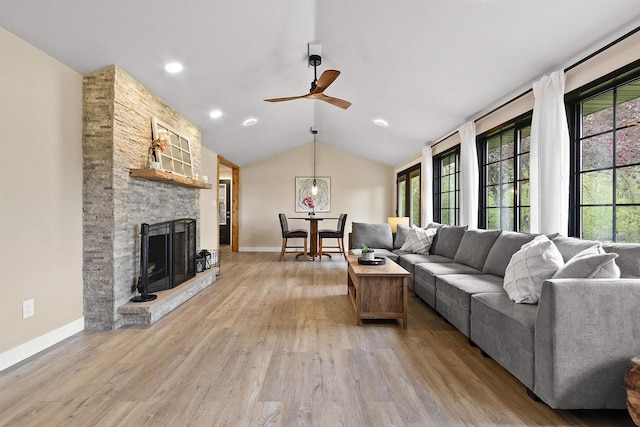 W1691 Fish Creek Rd, Seymour, WI 54165 - living area with light wood finished floors, ceiling fan, lofted ceiling, a fireplace, and baseboards