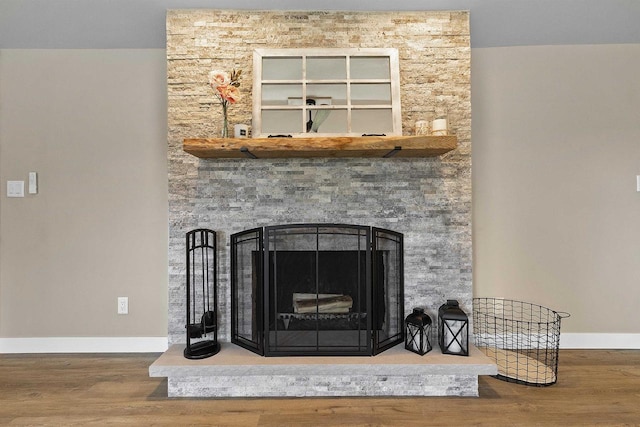 W1691 Fish Creek Rd, Seymour, WI 54165 - detailed view of wood finished floors, baseboards, and a stone fireplace
