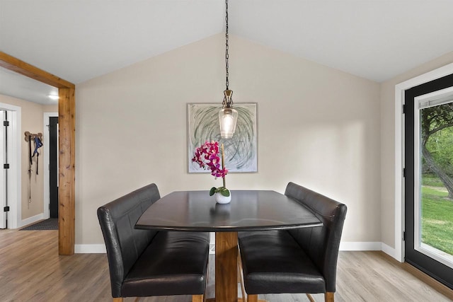 W1691 Fish Creek Rd, Seymour, WI 54165 - dining room featuring baseboards, light wood-style flooring, and vaulted ceiling