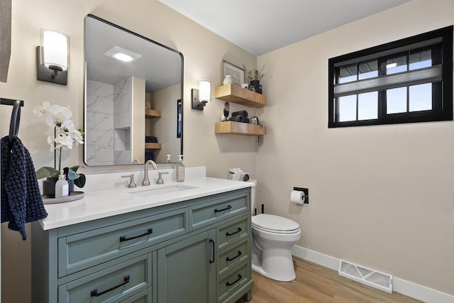 W1691 Fish Creek Rd, Seymour, WI 54165 - full bathroom with vanity, wood finished floors, toilet, baseboards, and a shower