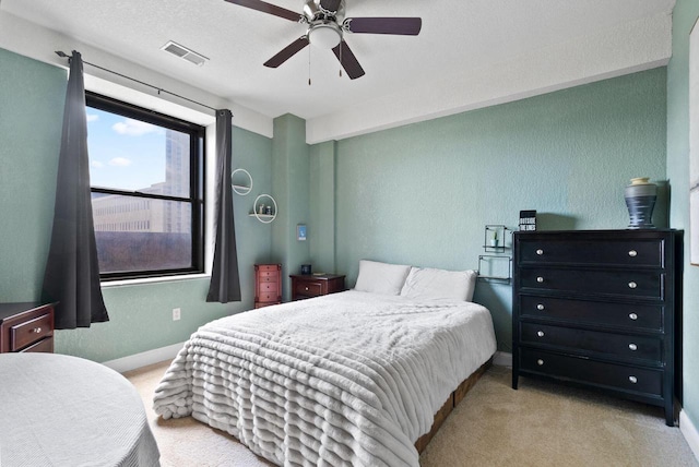 606 W Wisconsin Ave Unit 301, Milwaukee, WI 53203 - carpeted bedroom with a textured wall, baseboards, and a ceiling fan