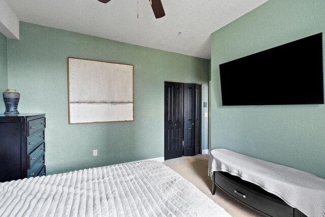 606 W Wisconsin Ave Unit 301, Milwaukee, WI 53203 - carpeted bedroom featuring a closet, a ceiling fan, a textured wall, and baseboards