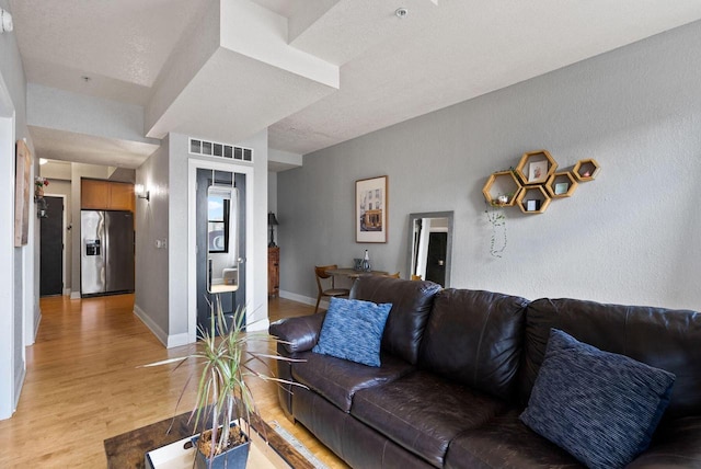 606 W Wisconsin Ave Unit 301, Milwaukee, WI 53203 - living room featuring light wood-type flooring and baseboards