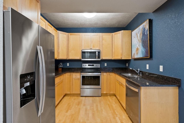 606 W Wisconsin Ave Unit 301, Milwaukee, WI 53203 - kitchen with appliances with stainless steel finishes, light brown cabinets, a sink, a textured wall, and a textured ceiling