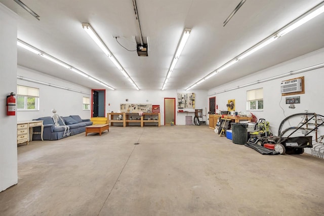 1817 Bonk Ln, Little Suamico, WI 54141 - garage featuring a garage door opener, an AC wall unit, and a workshop area
