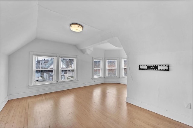 2505 N Oakland Ave Unit 2507, Milwaukee, WI 53211 - bonus room featuring plenty of natural light, lofted ceiling, hardwood / wood-style floors, and baseboards