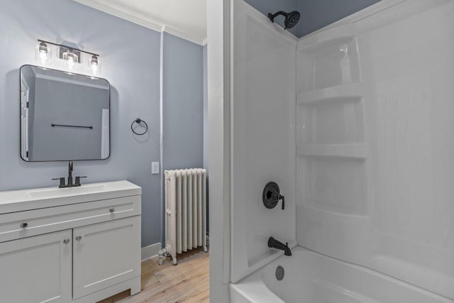 603 Spring St, Lake Geneva, WI 53147 - full bath with radiator, shower / bath combination, vanity, wood finished floors, and baseboards