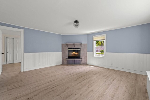 603 Spring St, Lake Geneva, WI 53147 - unfurnished living room with a wainscoted wall, wood finished floors, and a glass covered fireplace