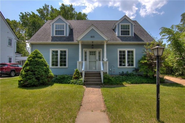 1805 Main St, Eau Claire, WI 54701 - cape cod-style house with a front yard and roof with shingles