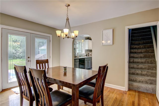1805 Main St, Eau Claire, WI 54701 - dining area featuring plenty of natural light, a chandelier, light wood-style floors, and stairs