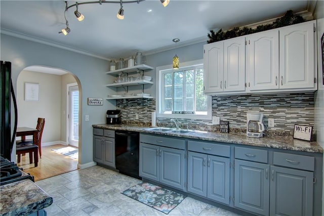 1805 Main St, Eau Claire, WI 54701 - kitchen with dishwasher, arched walkways, white cabinets, decorative backsplash, and ornamental molding