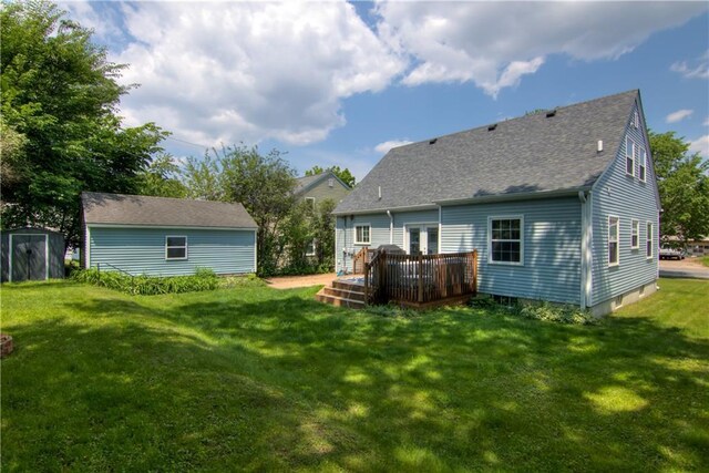 1805 Main St, Eau Claire, WI 54701 - rear view of property with a wooden deck, a lawn, a shingled roof, and an outbuilding