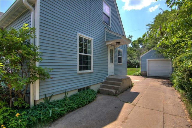 1805 Main St, Eau Claire, WI 54701 - view of side of property featuring driveway, an outbuilding, and a detached garage