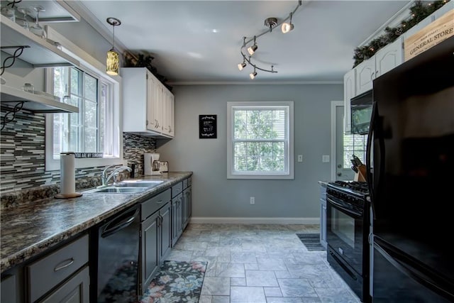 1805 Main St, Eau Claire, WI 54701 - kitchen with black appliances, a sink, decorative backsplash, baseboards, and white cabinets