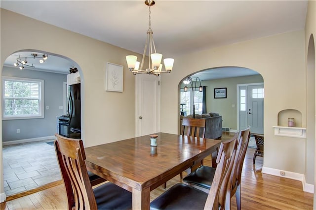 1805 Main St, Eau Claire, WI 54701 - dining room featuring arched walkways, a chandelier, and plenty of natural light