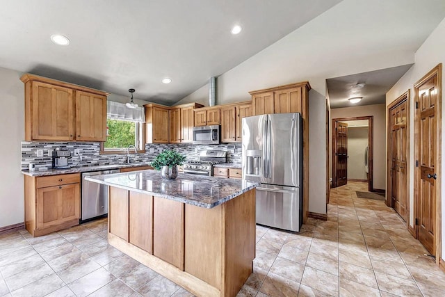 3251 Bower Creek Rd, De Pere, WI 54115 - kitchen with appliances with stainless steel finishes, decorative backsplash, dark stone countertops, lofted ceiling, and a center island