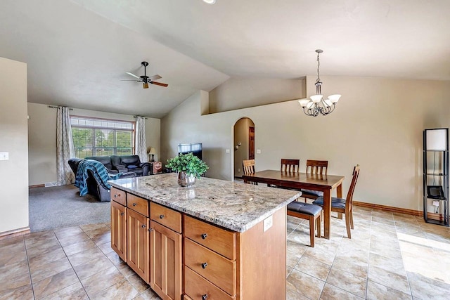 3251 Bower Creek Rd, De Pere, WI 54115 - kitchen featuring a ceiling fan, arched walkways, a kitchen island, open floor plan, and vaulted ceiling