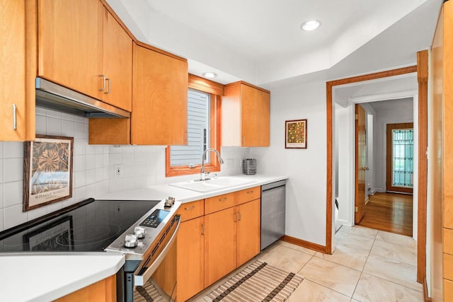 5160 N Idlewild Ave, Whitefish Bay, WI 53217 - kitchen with appliances with stainless steel finishes, under cabinet range hood, light countertops, and backsplash