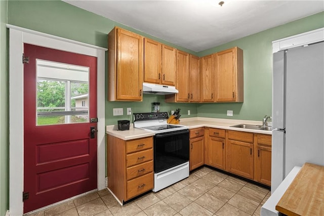 1528 Bellevue Ave, Eau Claire, WI 54703 - kitchen with electric range oven, under cabinet range hood, a sink, freestanding refrigerator, and light countertops