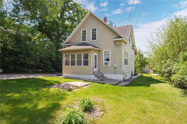 1528 Bellevue Ave, Eau Claire, WI 54703 - rear view of property featuring entry steps, a shingled roof, a yard, and a chimney