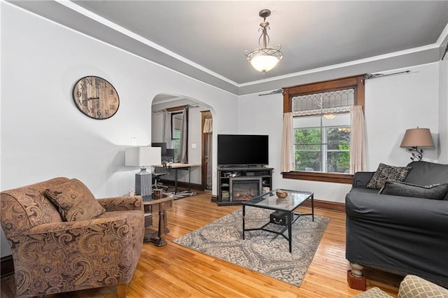 1528 Bellevue Ave, Eau Claire, WI 54703 - living area with arched walkways, wood finished floors, baseboards, and crown molding