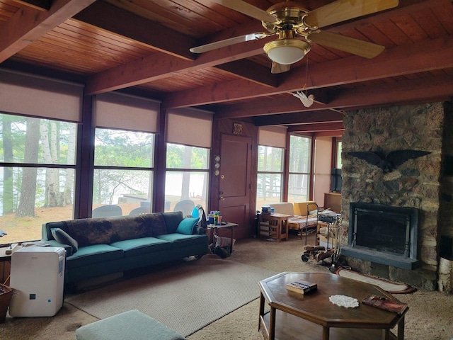 N9225 Sumac Ln, Gresham, WI 54128 - living room with wooden ceiling with exposed beams, a ceiling fan, a fireplace, and carpet flooring