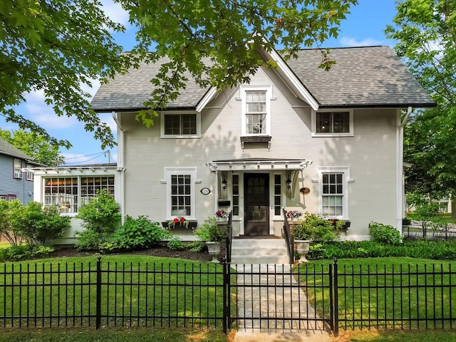 234 Warren St, Lake Geneva, WI 53147 - english style home featuring a shingled roof and a gate