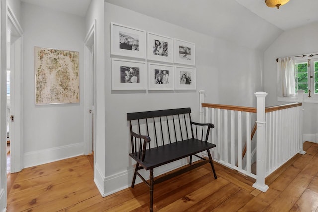 234 Warren St, Lake Geneva, WI 53147 - sitting room featuring light wood finished floors, lofted ceiling, an upstairs landing, and baseboards