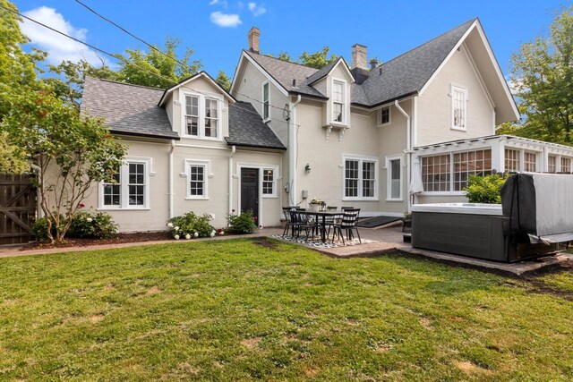234 Warren St, Lake Geneva, WI 53147 - back of house with a hot tub, a patio, a shingled roof, a chimney, and a sunroom