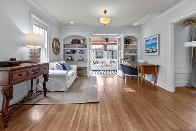 234 Warren St, Lake Geneva, WI 53147 - living room with built in shelves, crown molding, ceiling fan, and wood finished floors